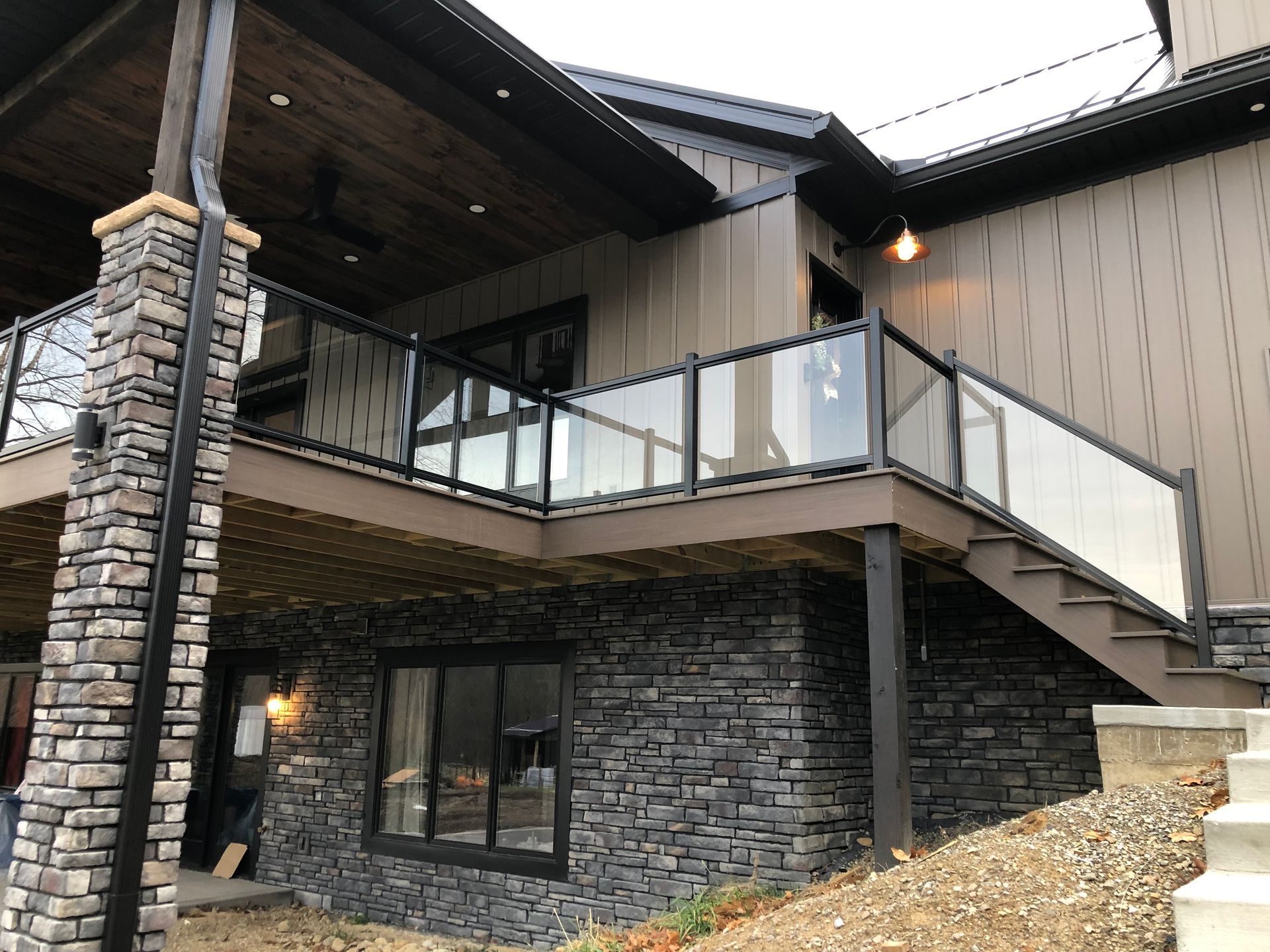 A house with a deck and stairs on the side of it