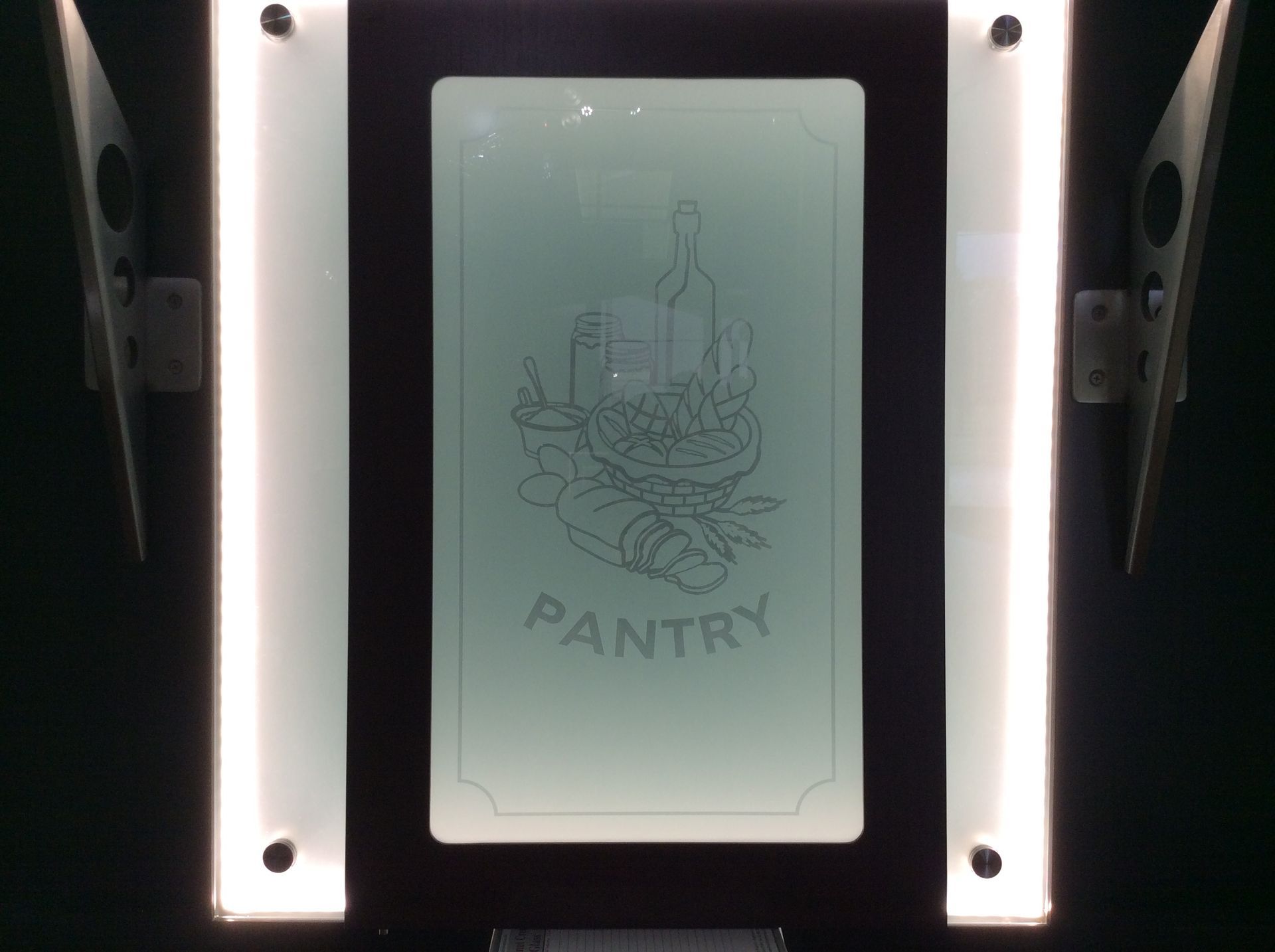 A pantry sign with a picture of food on it