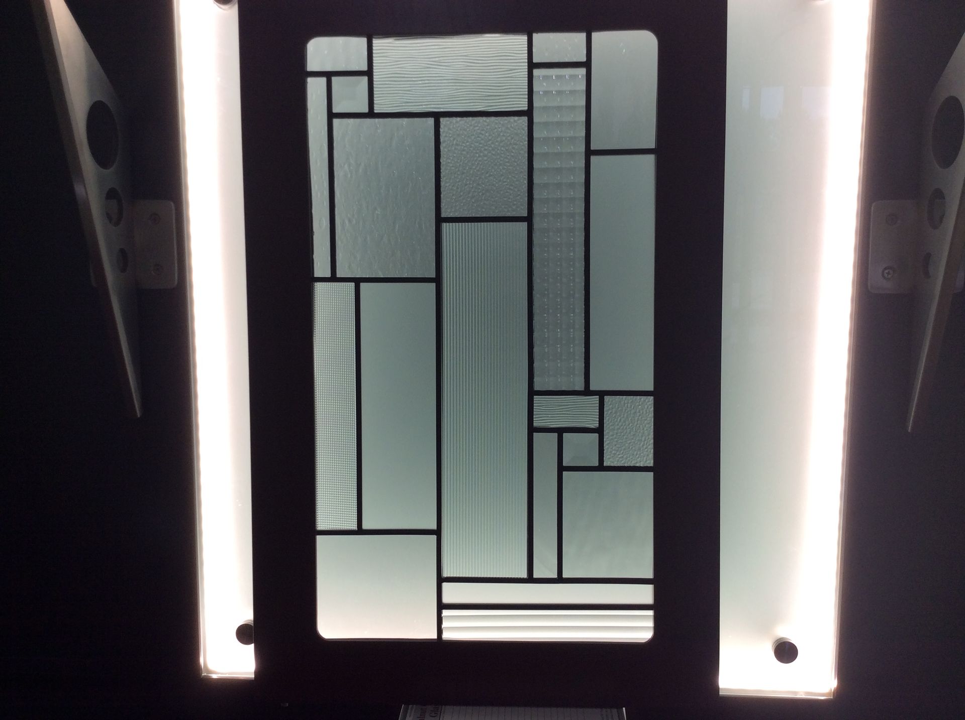 A stained glass window in a dark room