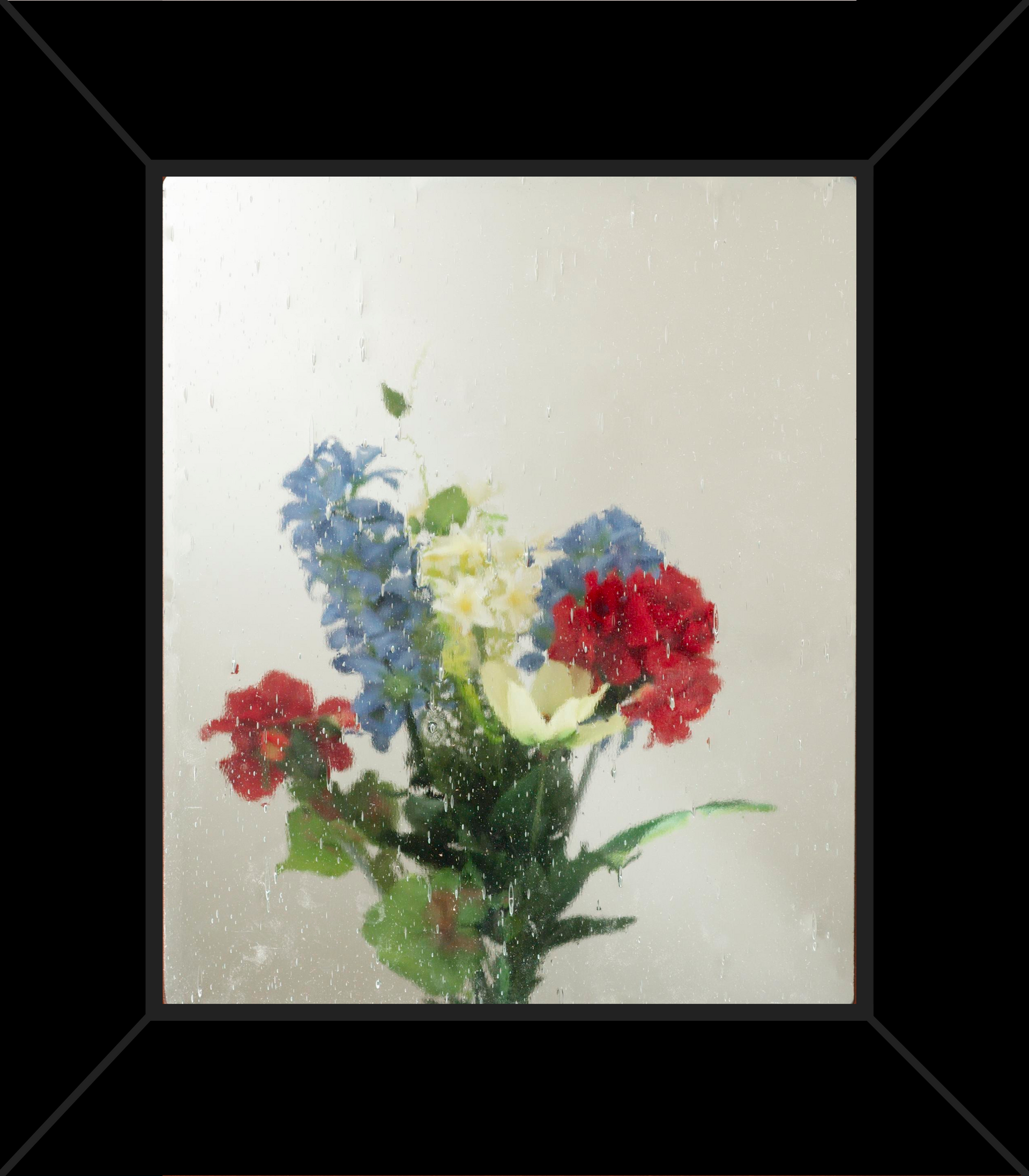 A picture of flowers in a vase with a black frame