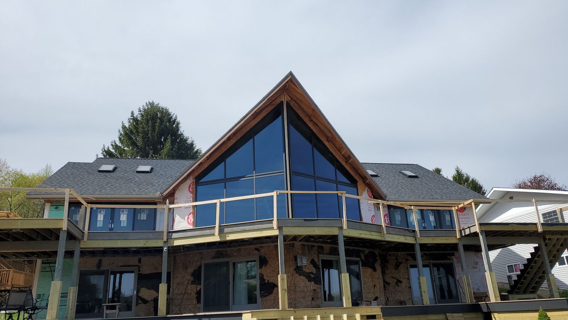 A large house with a lot of windows is being built.