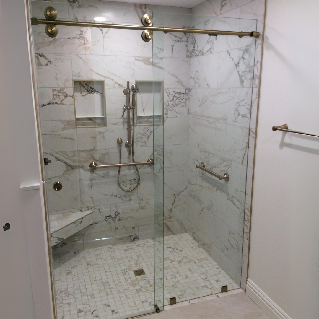 A bathroom with a walk in shower with a sliding glass door.