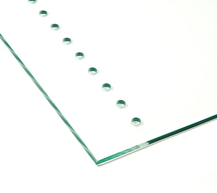 A piece of glass with holes in it on a white background