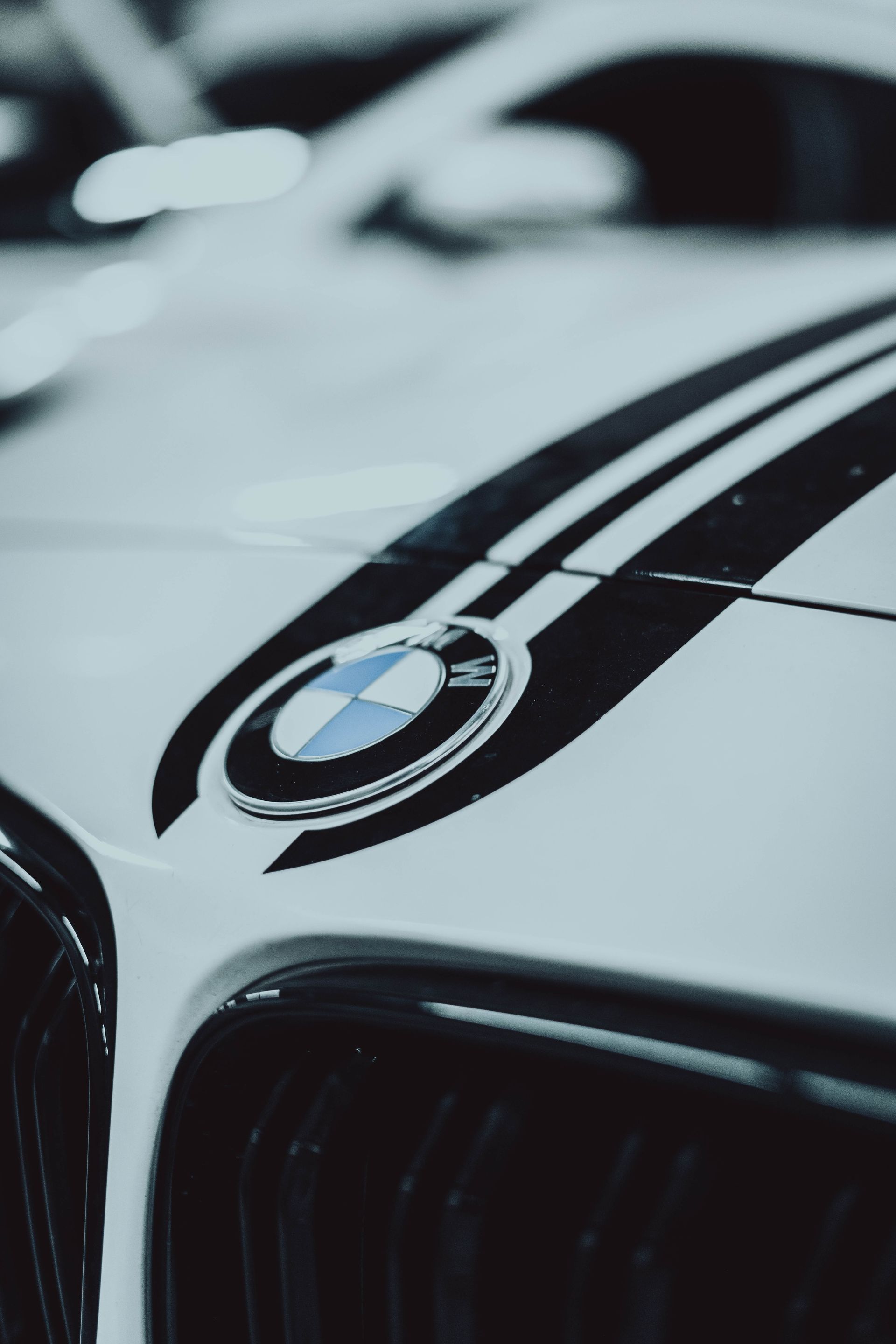 A close up of the hood of a white bmw