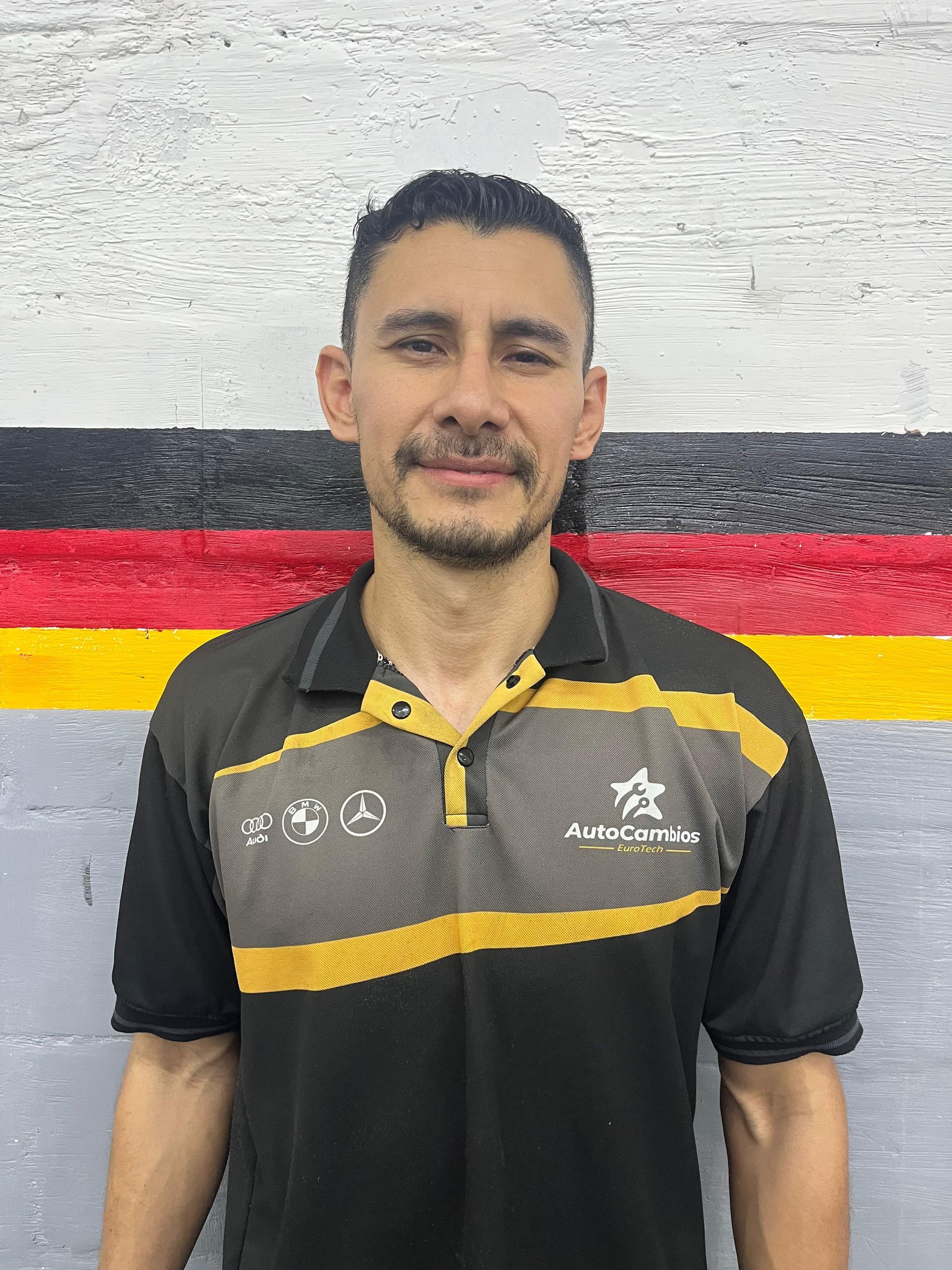 A woman in a green shirt is laughing with her mouth open