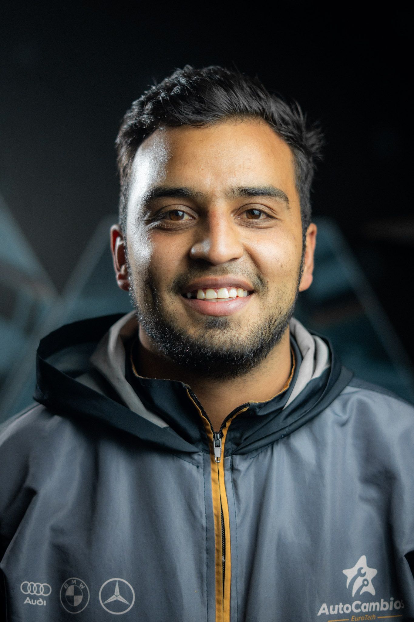 A man wearing a jacket with the word auto on it