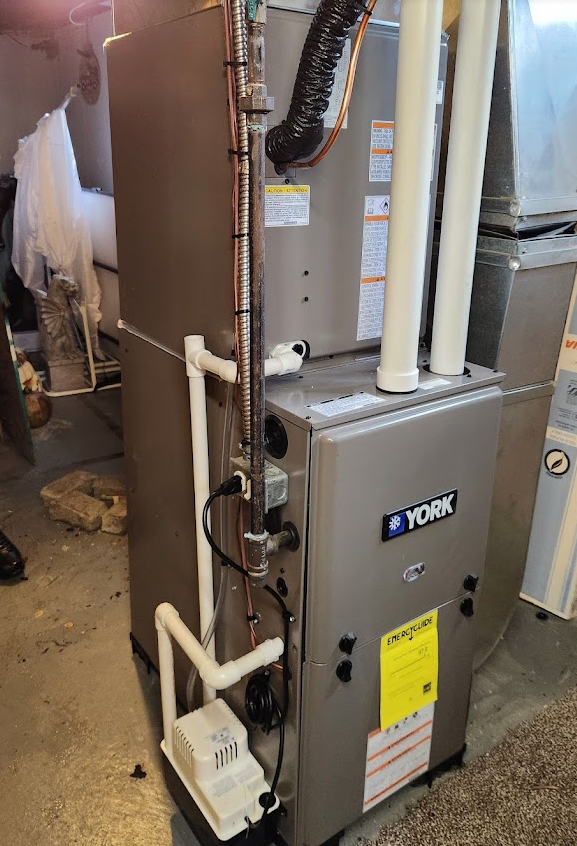 A York furnace in a home setting, with connected pipes and ductwork. In Allen park mi.