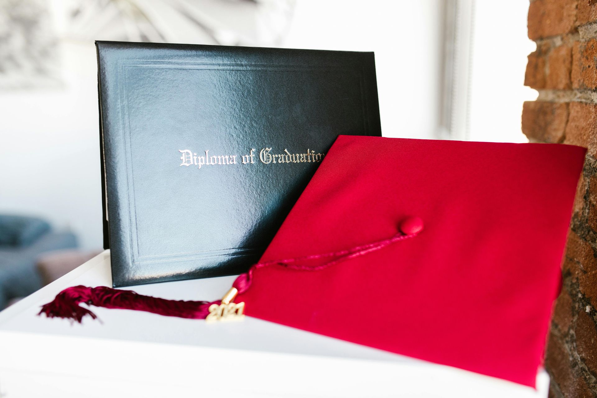 Graduating students tossing caps in the air during a ceremony; black backdrop.