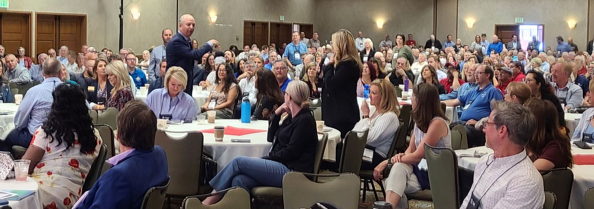 Matt is facilitating a conversation in a large and crowded ballroom.