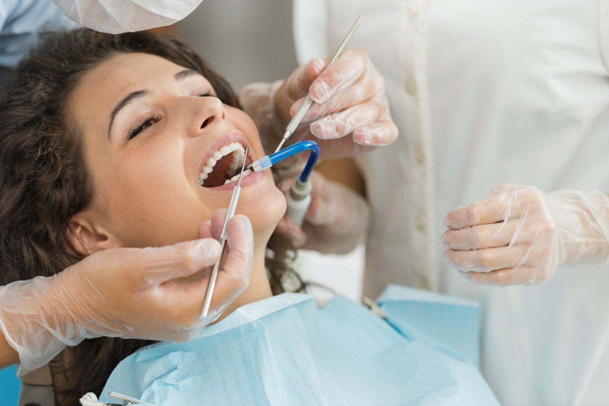 A woman being prepped for tooth extraction.