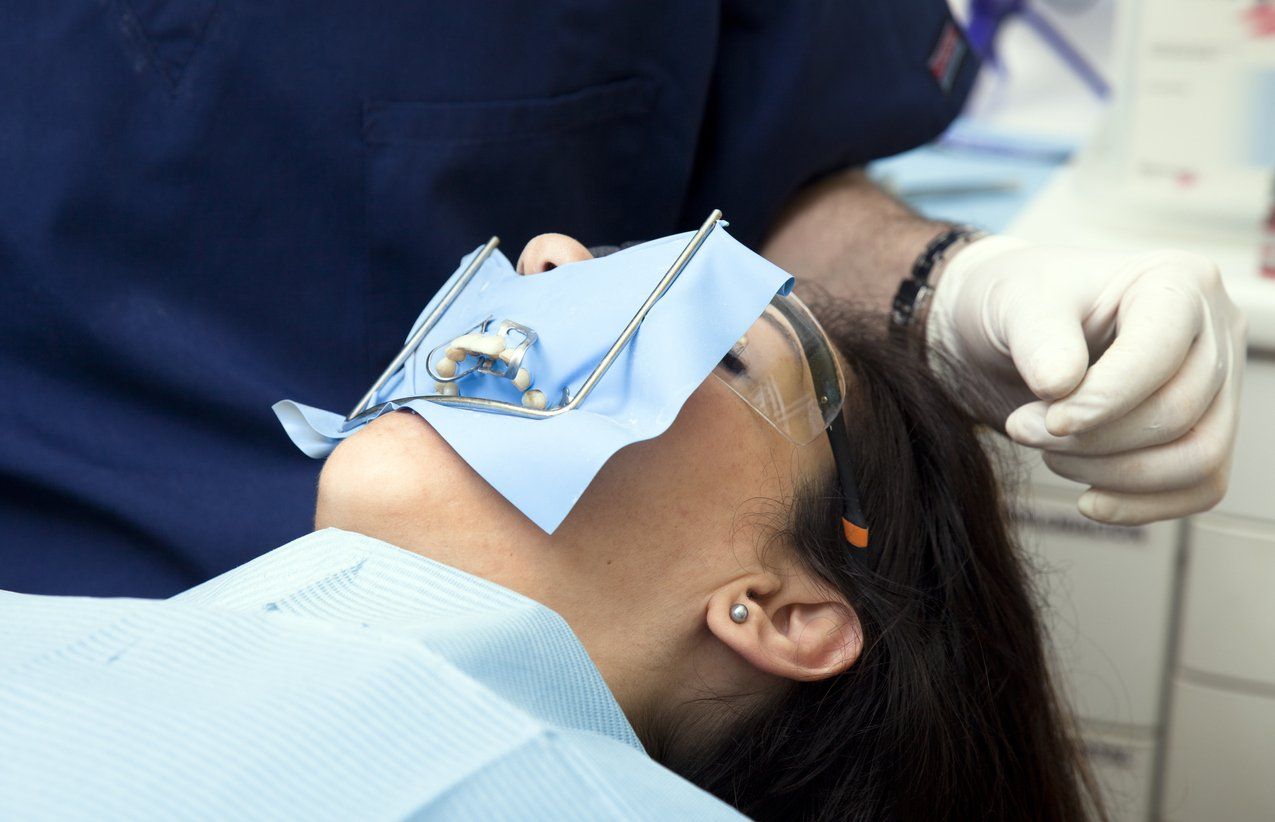 dental patient receiving a bridge from dentist