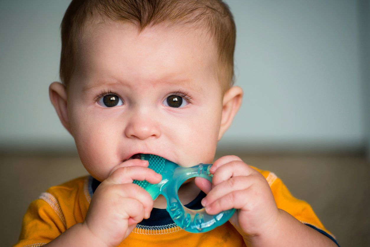 baby teething on a teething ring