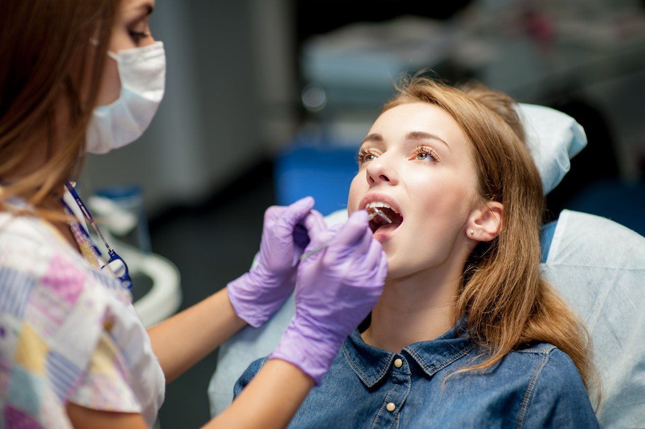 teen at dental check up to ensure placement of crowns and bridges