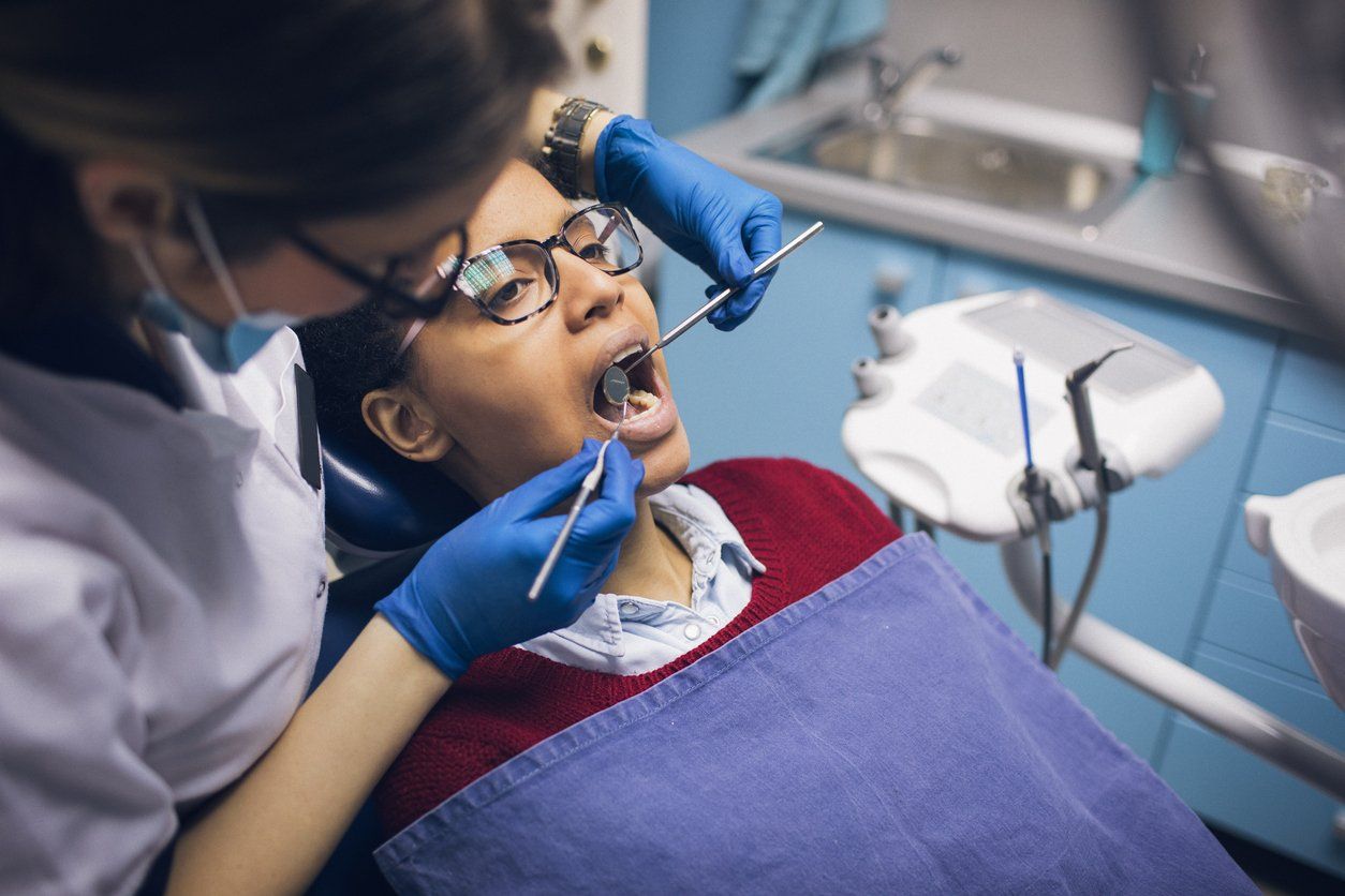 woman at dental check up preforming good oral hygiene