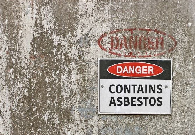 Danger sign on weathered wall reading