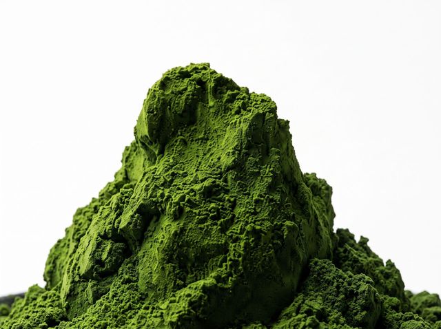 Green powder mound on a white background