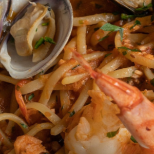 A group of people sitting around a conference table in an office, discussing a digital presentation.