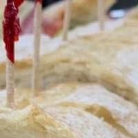 A group of people sitting around a conference table in an office, discussing a digital presentation.