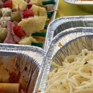A group of people sitting around a conference table in an office, discussing a digital presentation.