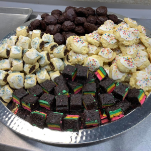 A group of people sitting around a conference table in an office, discussing a digital presentation.