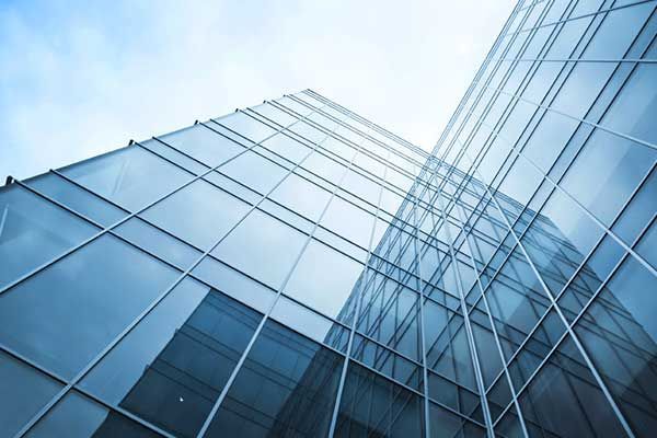 Modern building with reflective glass windows showcasing commercial glass. Modern building with reflective glass windows showcasing commercial glass.