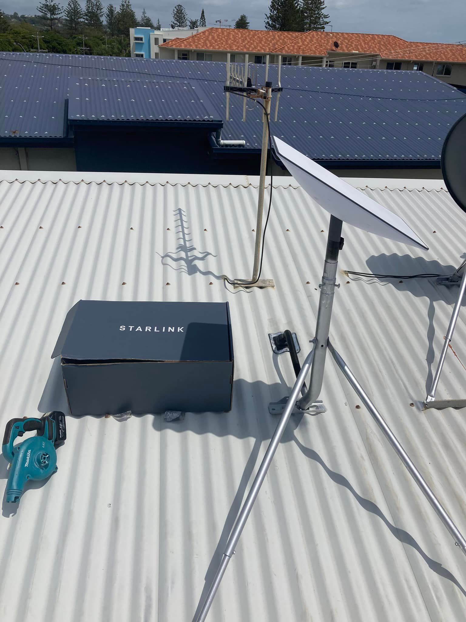 A Rooftop Scene With a Starlink Box and Dish, and Antenna on a Metal Roof — BRC Antenna Service 1 In Ballina, NSW