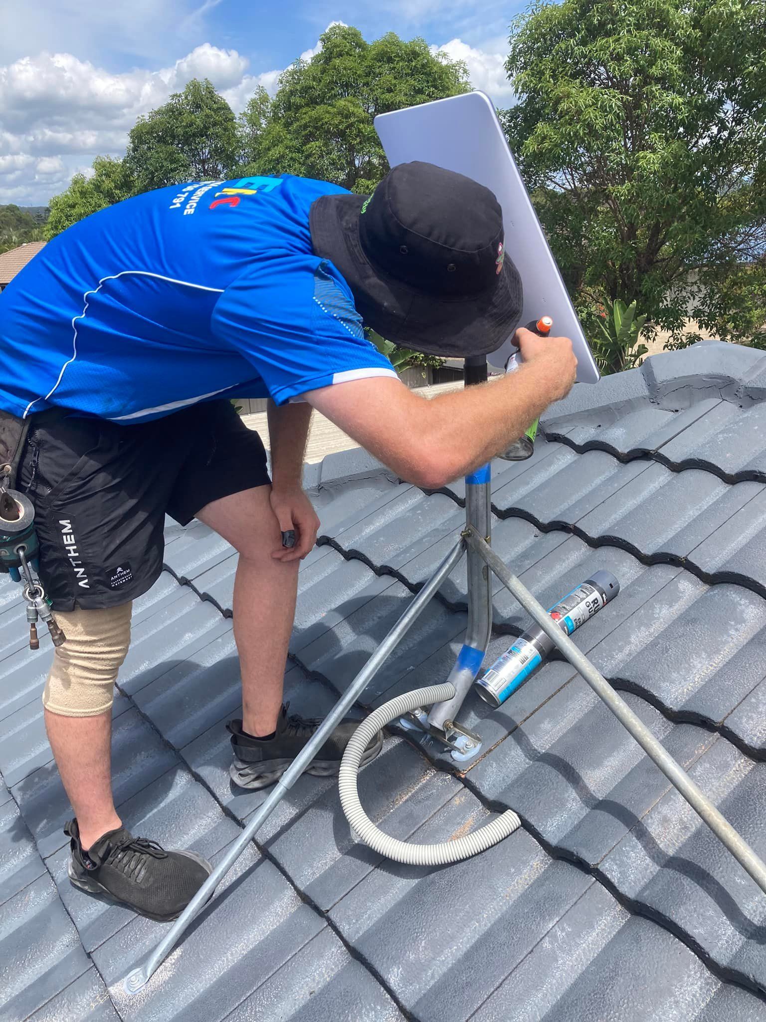 Person on Roof, Adjusting Antenna — BRC Antenna Service 1 In Banora Point, NSW
