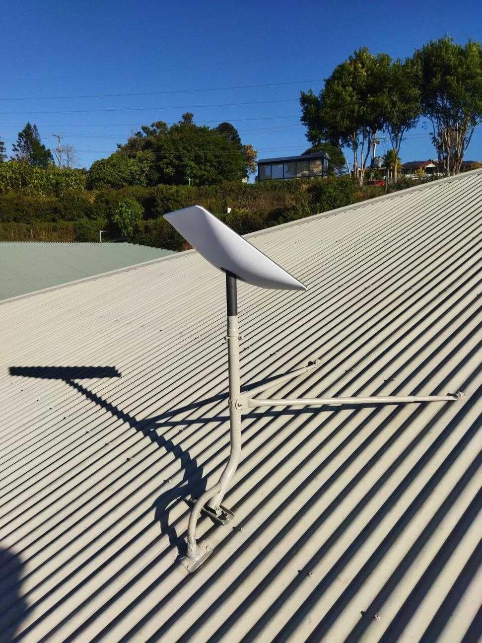 A White Starlink Satellite Dish Mounted on a Corrugated Metal Roof — BRC Antenna Service 1 In Byron Bay, NSW