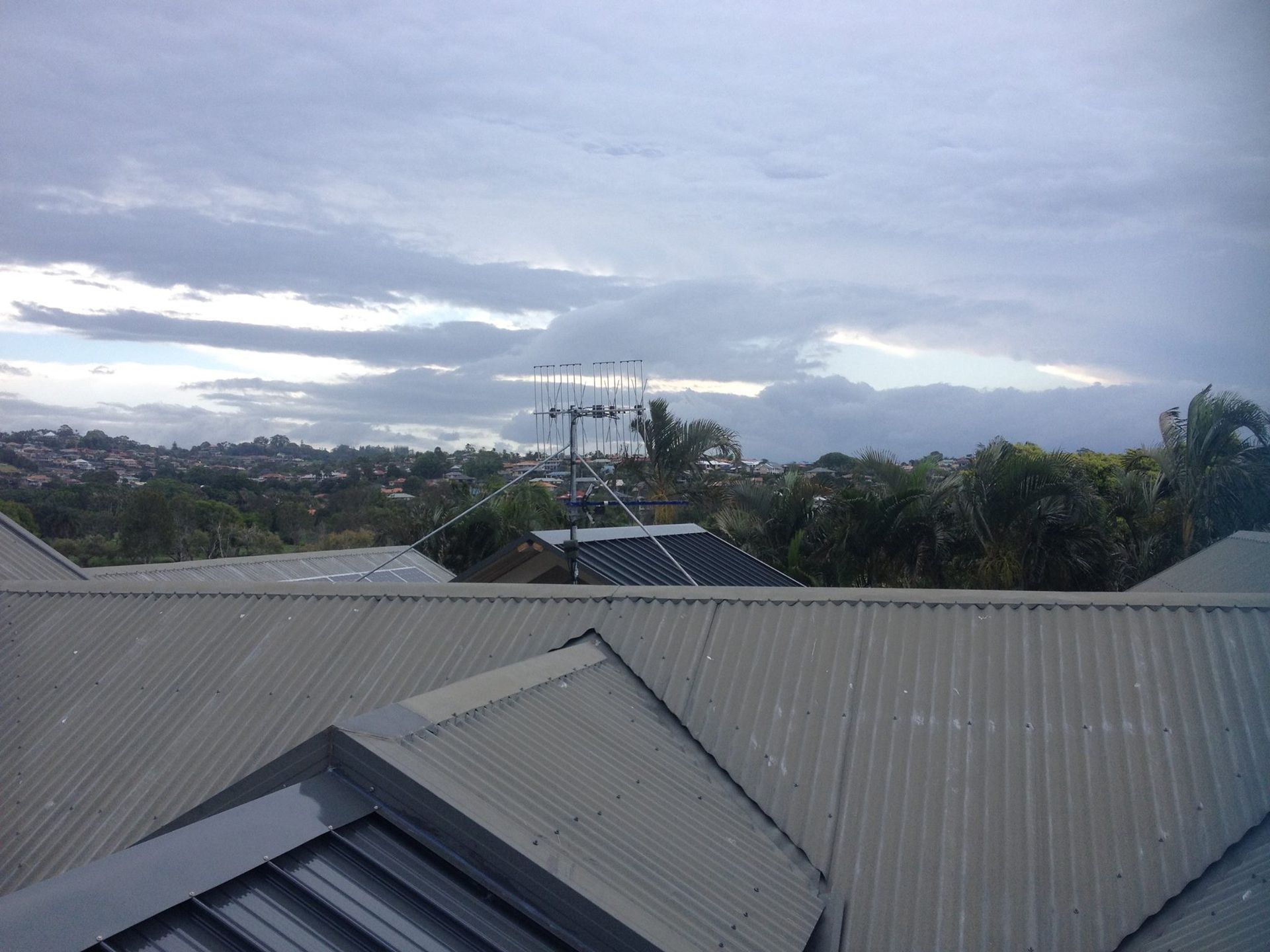 Overhead View of Rooftops With Cloudy Sky, Antenna Visible — BRC Antenna Service 1 In Ballina, NSW