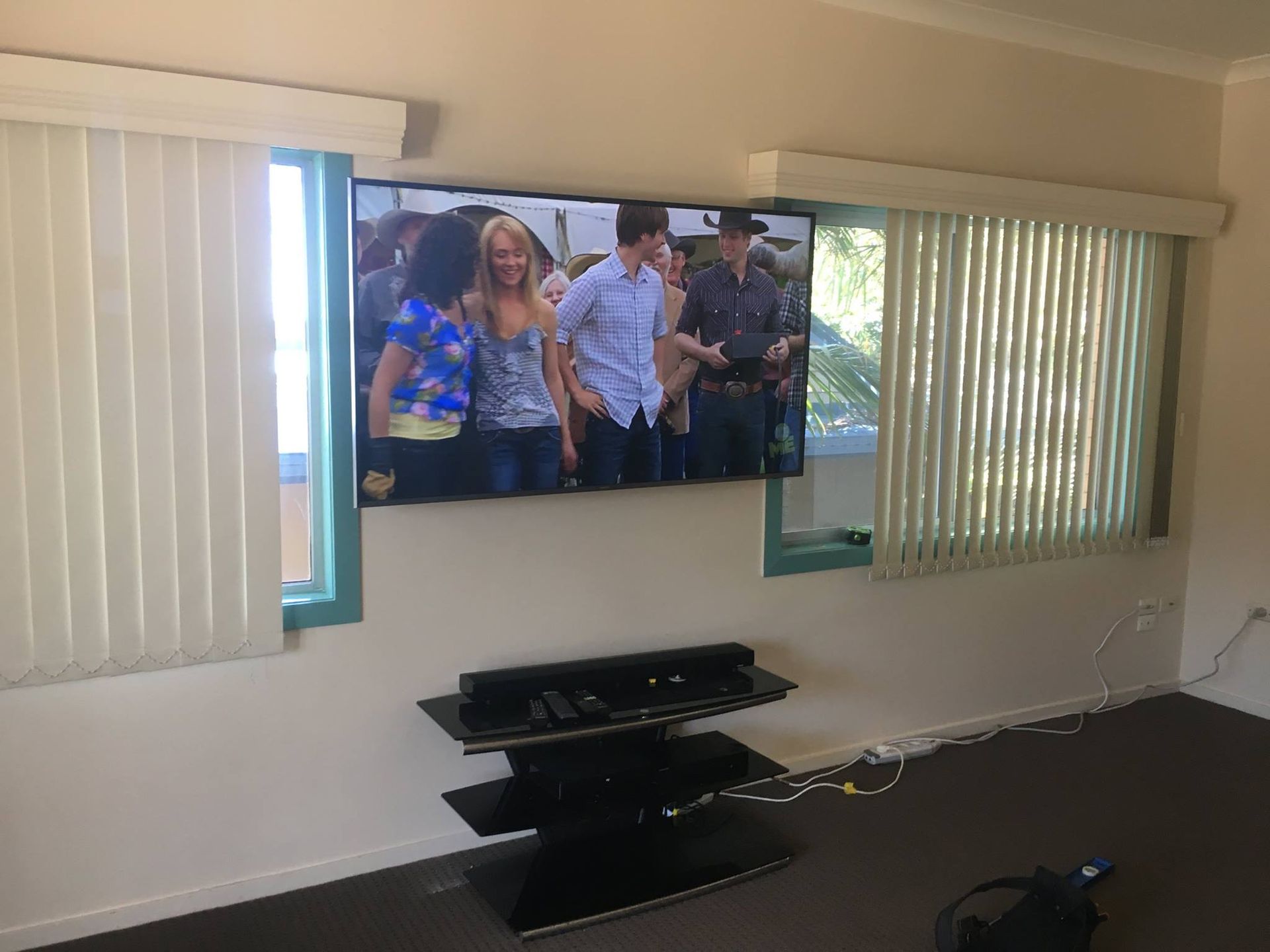 TV Mounted on a Wall With Windows on Either Side — BRC Antenna Service 1 In Byron Bay, NSW