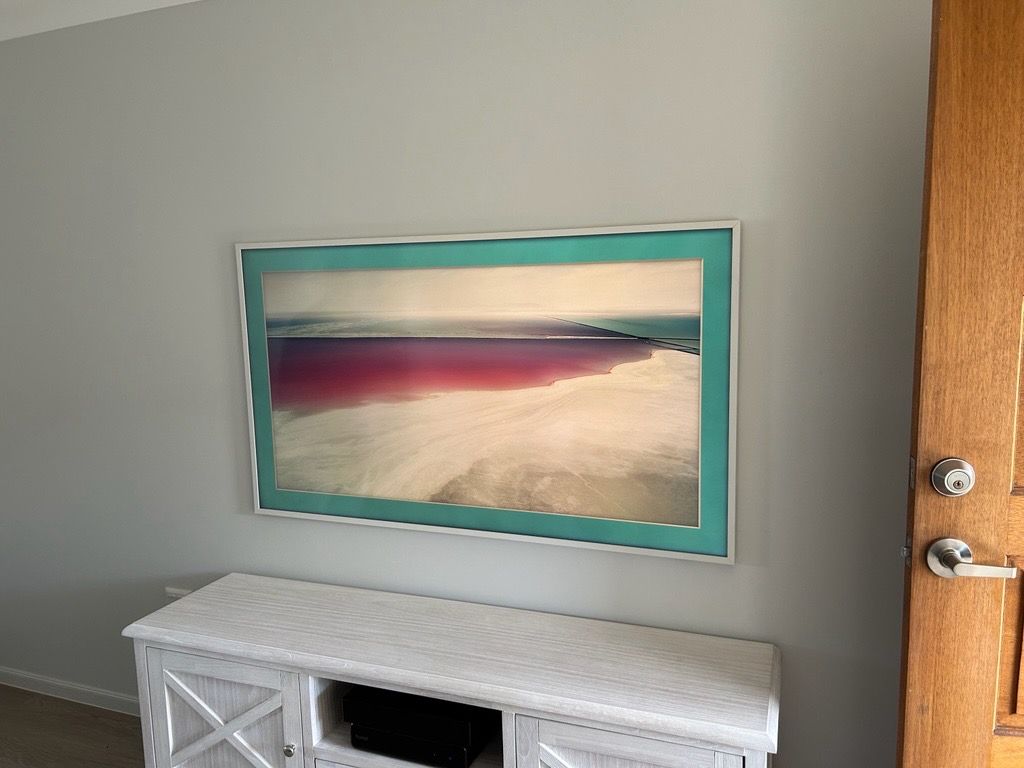 A TV on a Tan Wall Shows a Scene With Two People — BRC Antenna Service 1 In Banora Point, NSW