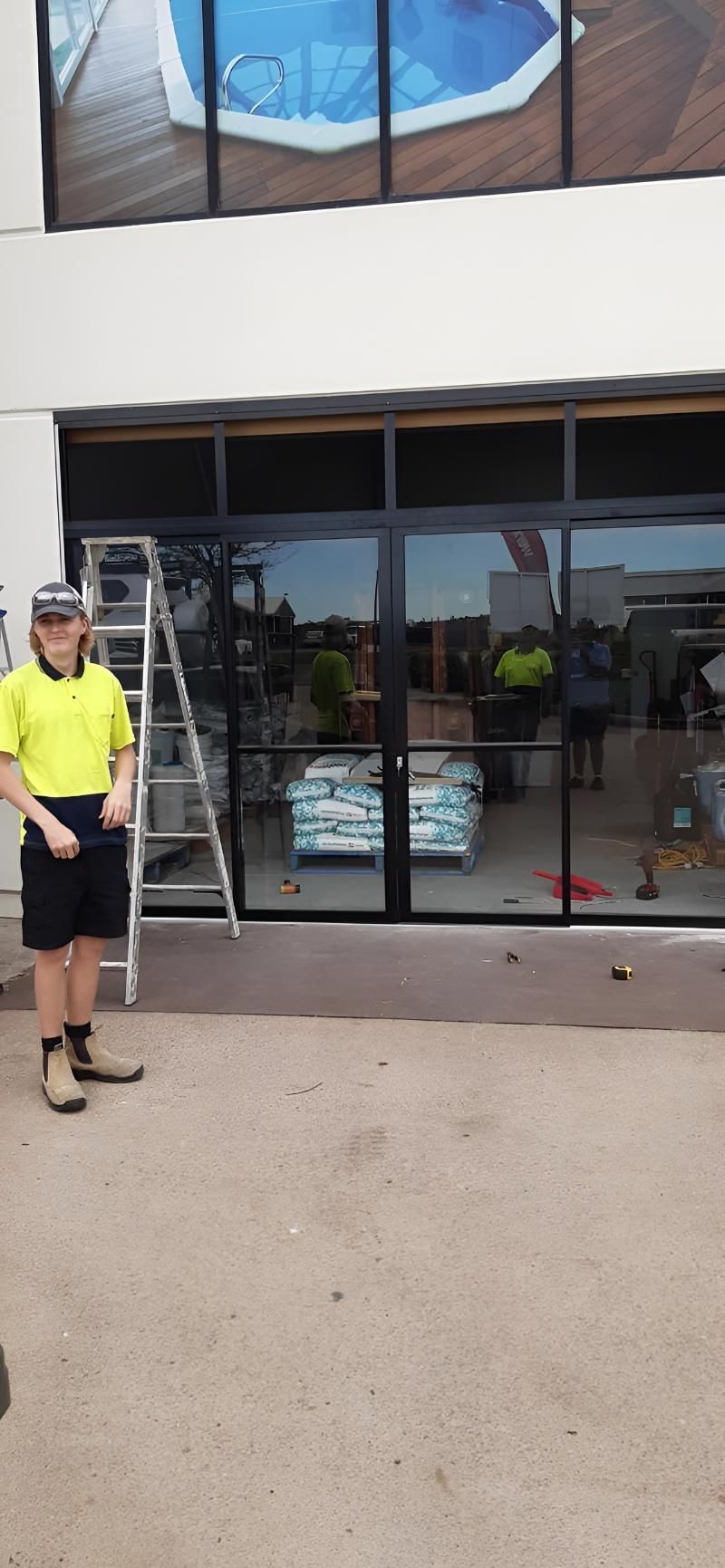 Glass Door Installation With Reflection of Worker — Hervey Bay Glass Glazing & Screens In Maryborough, QLD