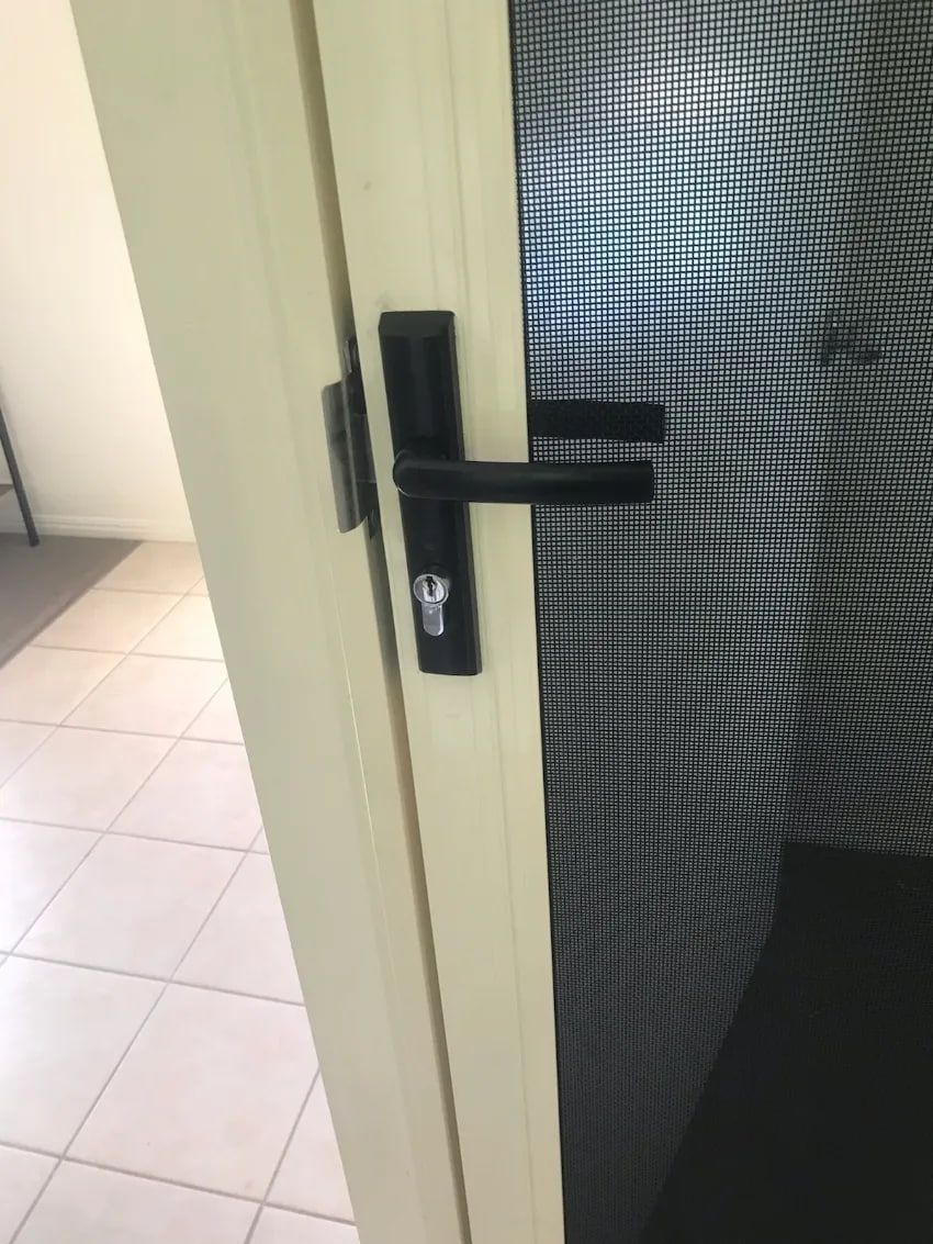 A Close up Of a Door with A Black Handle in A Room — Hervey Bay Glass Glazing & Screens In Pialba, QLD