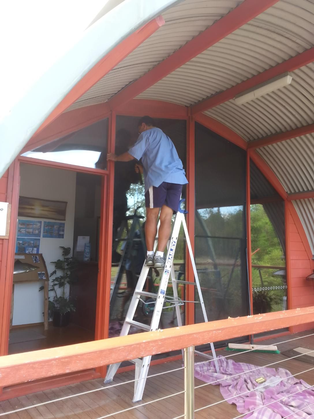 Man Installing New Glass for House — Hervey Bay Glass Glazing & Screens In Pialba, QLD