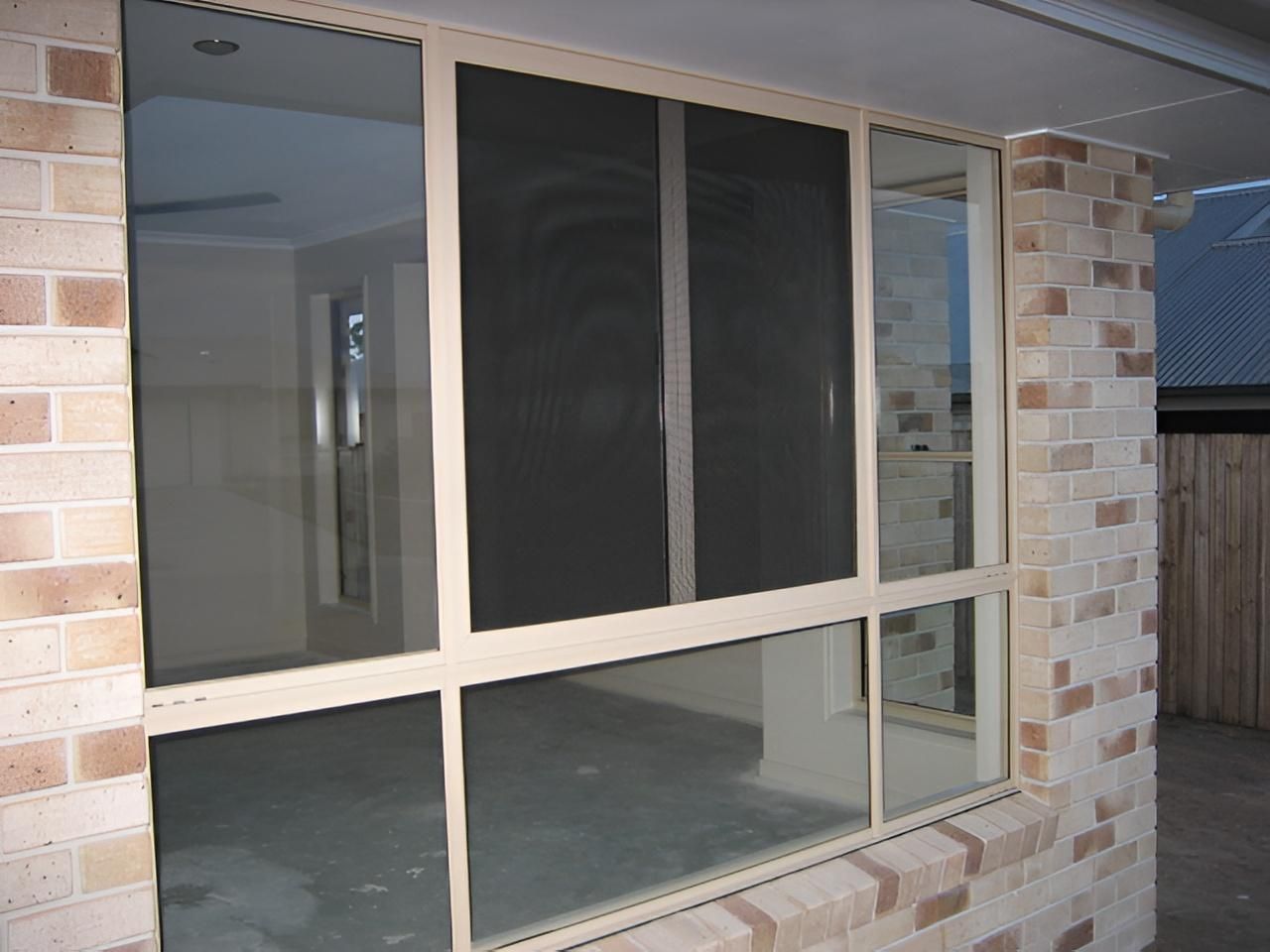Beige-framed Window With a Flyscreen — Hervey Bay Glass Glazing & Screens In Maryborough, QLD