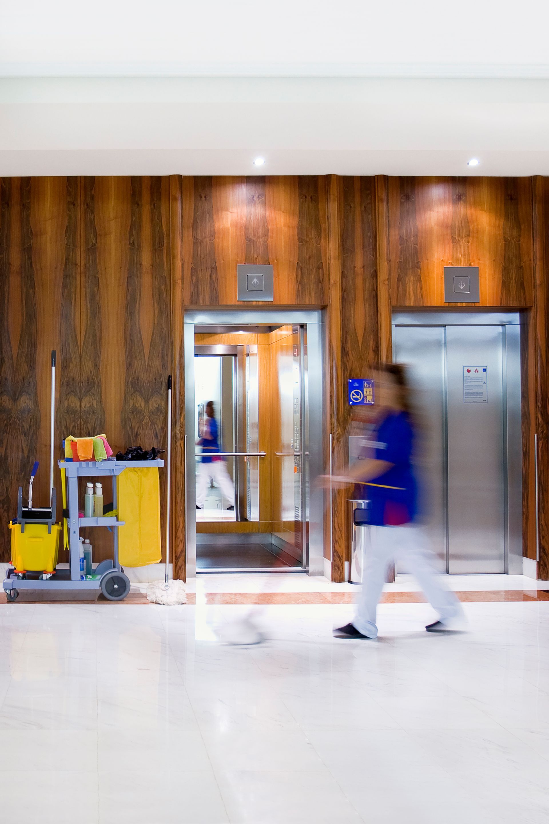 Woman vacuuming the sofa while professionally cleaning an apartment - Ottumwa, IA - Heaven's Best Ottumwa, IA