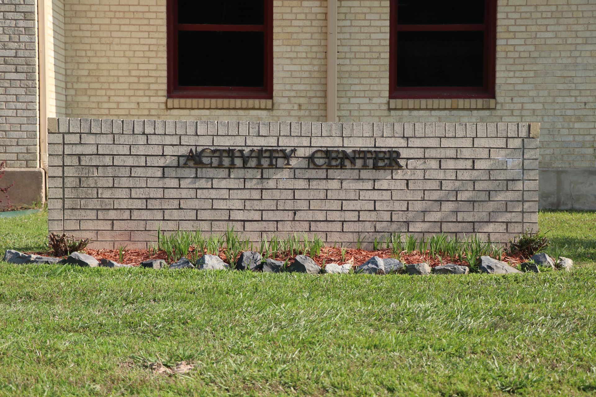 A brick wall with the word activity center written on it