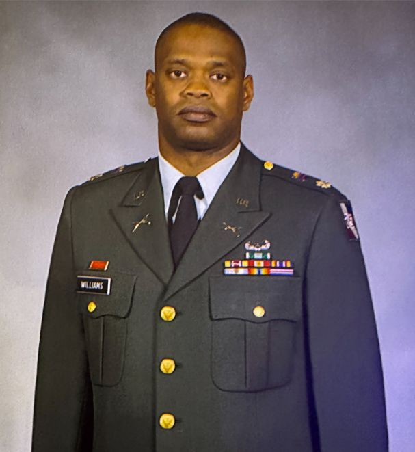 Lieutenant Colonel Clinton Tyrone Williams wearing a formal U.S. Army dress uniform for an official.