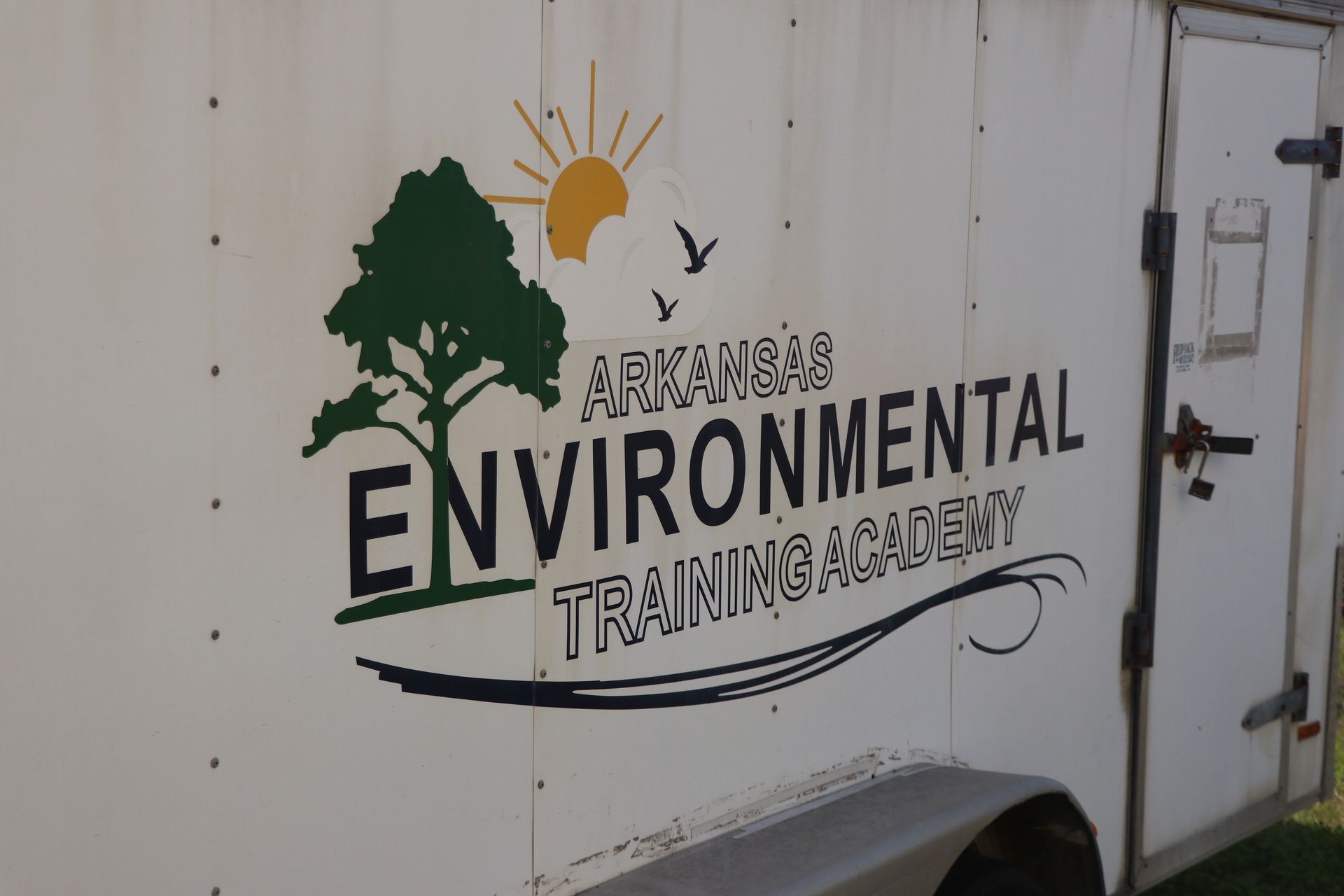 A white trailer with arkansas environmental training academy written on it