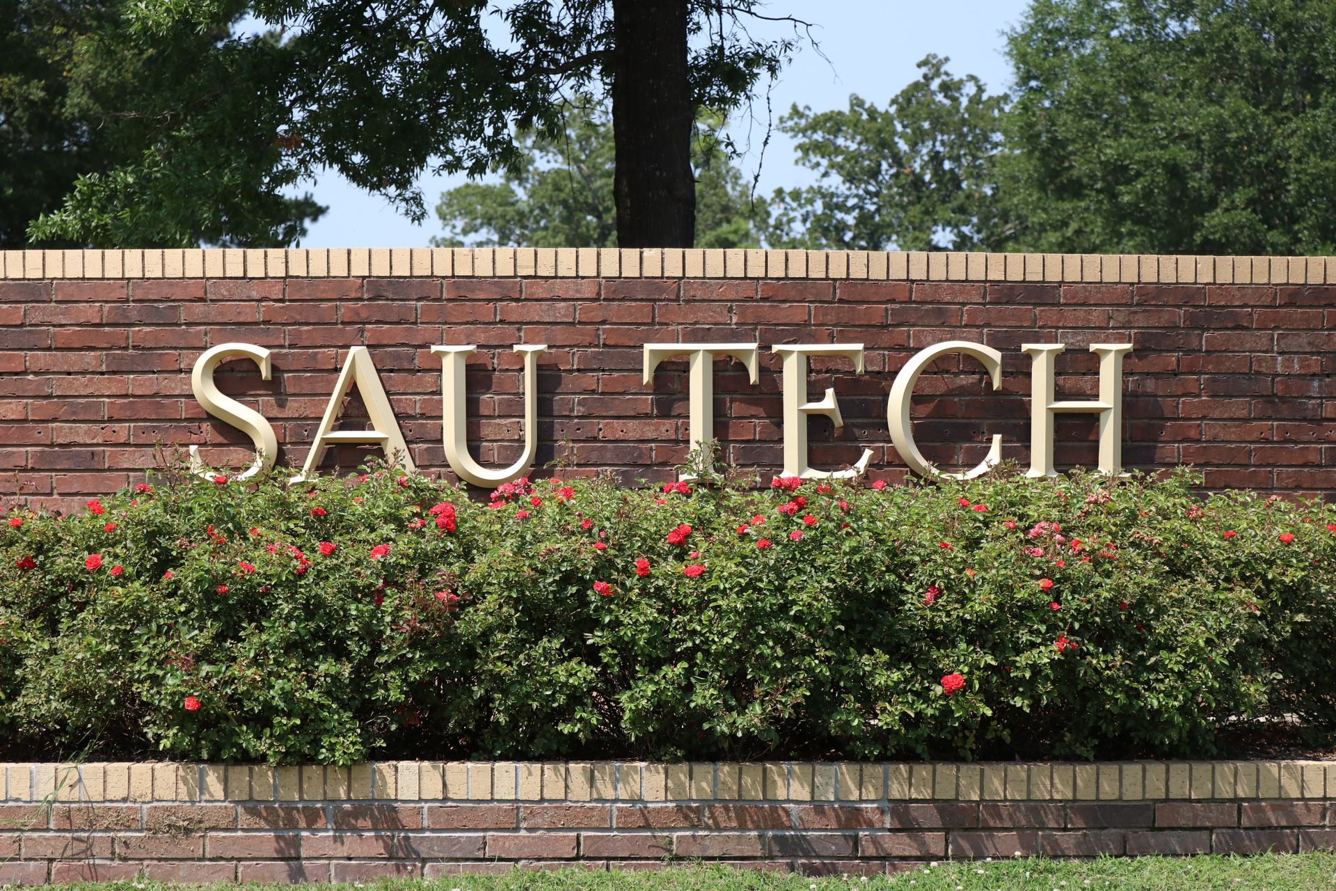 A brick wall with sau tech written on it