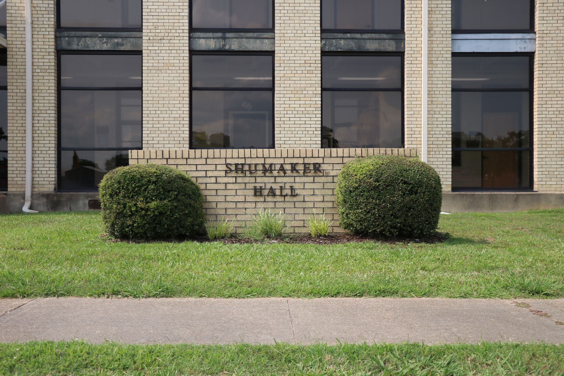 A brick building with a sign that says krupake hall