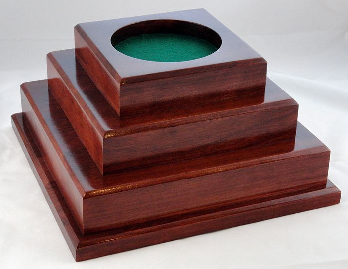 A pyramid shaped wooden box with a hole in the middle