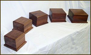 Four wooden boxes are lined up on a table.