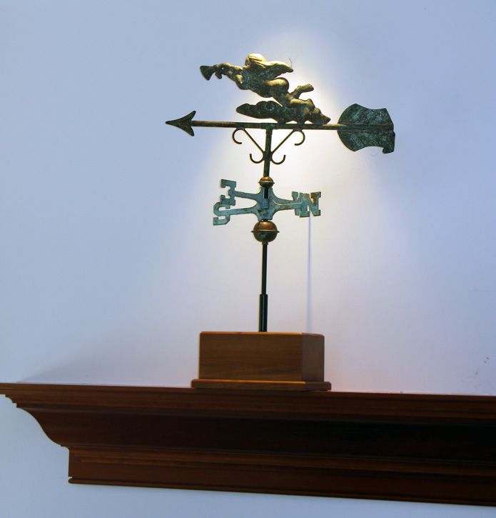 A weather vane with an arrow pointing to the right