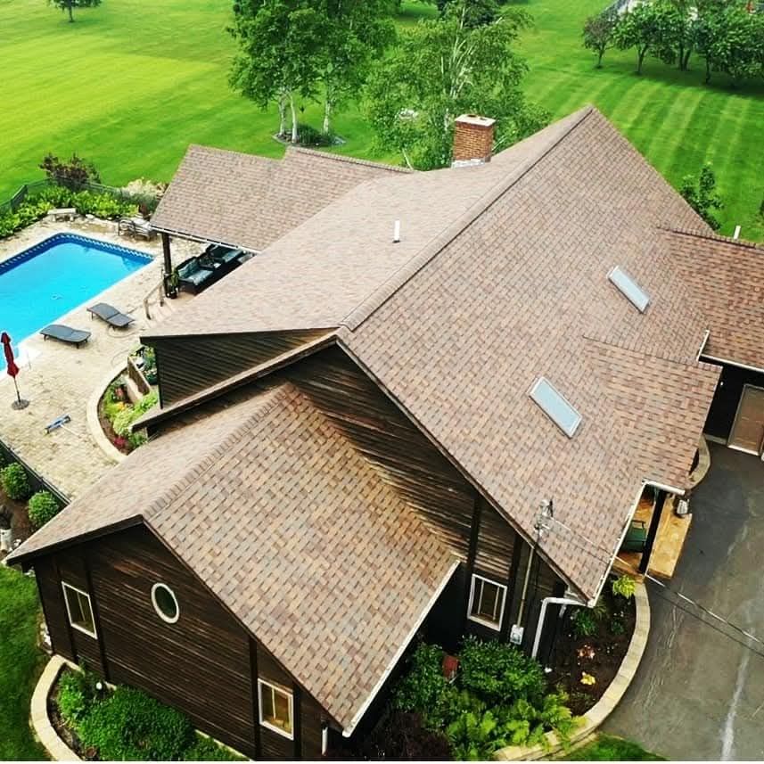 An aerial view of a house with a swimming pool