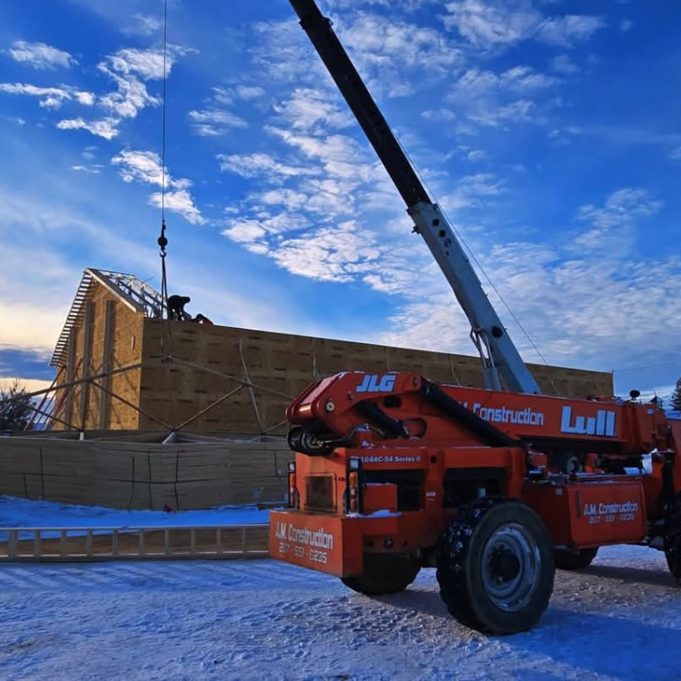 A construction crane is parked in front of a building