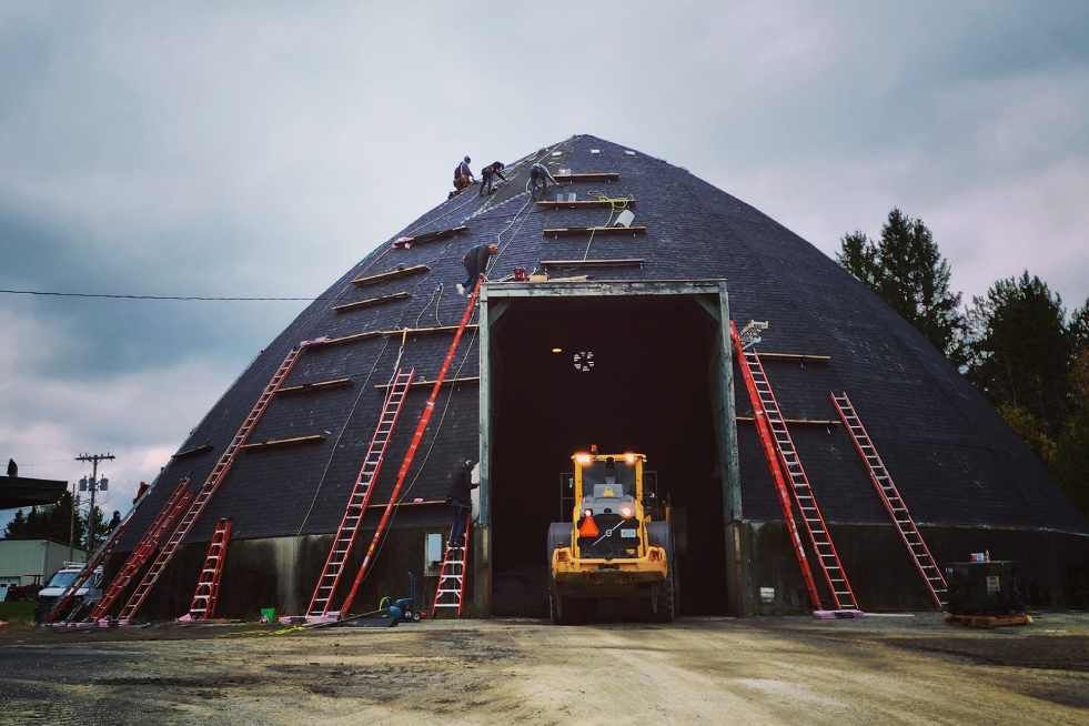 A large dome with a bulldozer inside of it