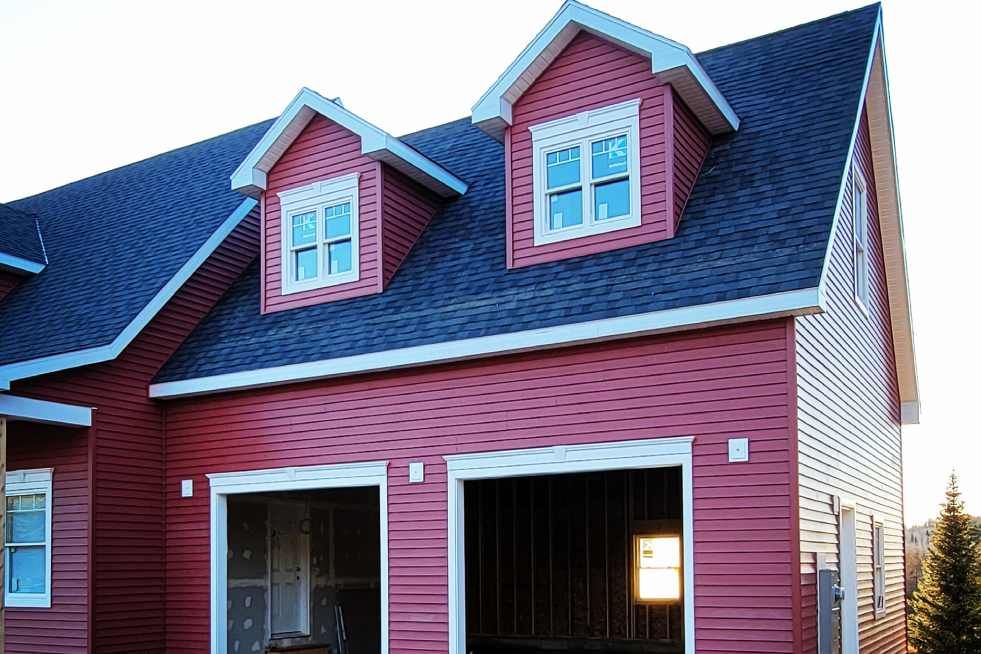 A red house with a blue roof and white trim