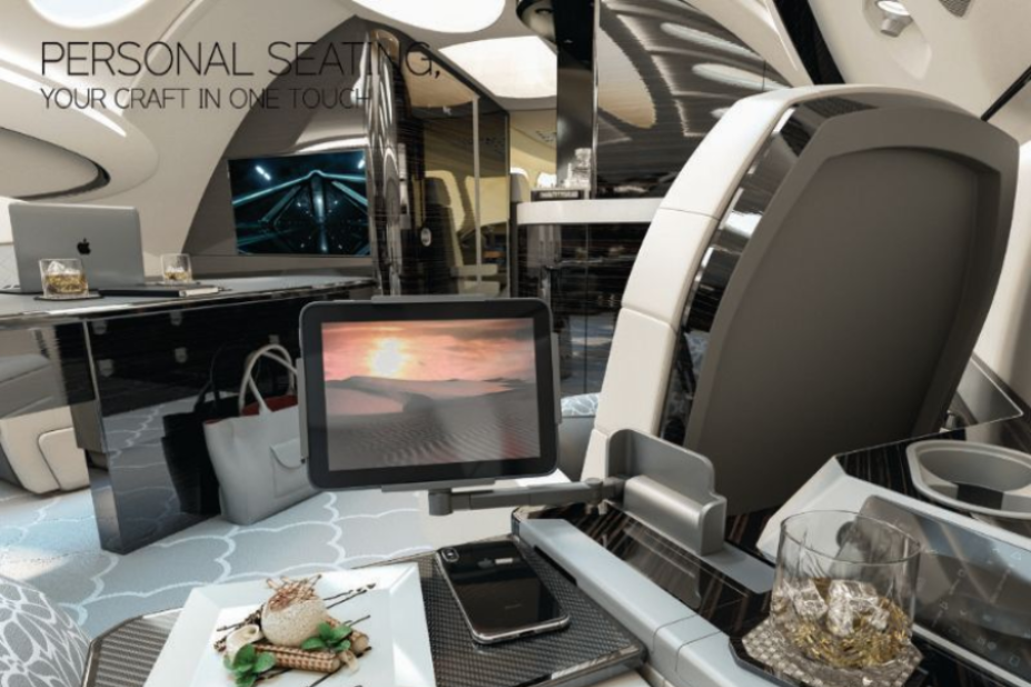 Luxury airplane interior with personal seating, monitor, food tray, and laptop.