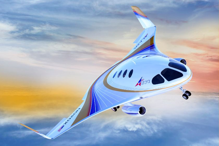 Futuristic airplane with sweeping wing design, blue, white, and gold accents, against a sunset sky.